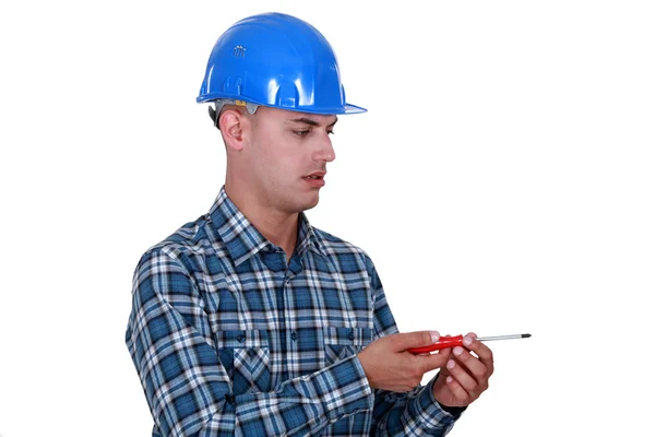 Laborer with screwdriver, studio shot — Stock Photo, Image