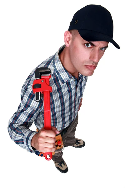 An angry man with a wrench. — Stock Photo, Image