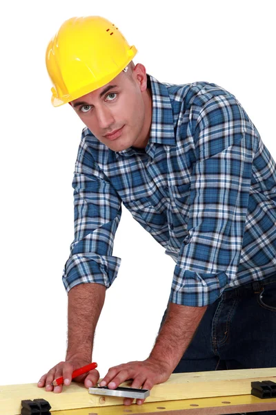 Carpenter marking a piece of wood — Stock Photo, Image
