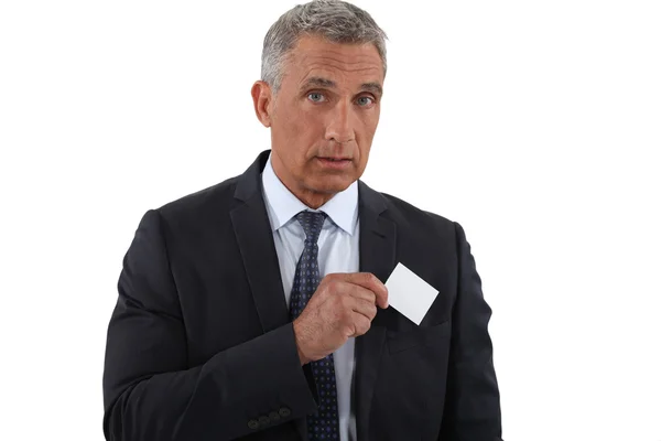 Executive pulling businesscard from pocket — Stock Photo, Image