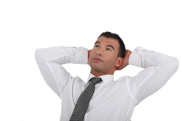 Businessman stretching his arms behind his head — Stock Photo, Image