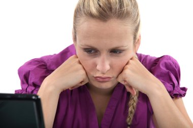 Employee pouting in front of her computer clipart