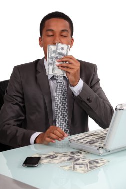 A con man smelling his loot clipart