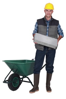 Stonemason carrying a block clipart