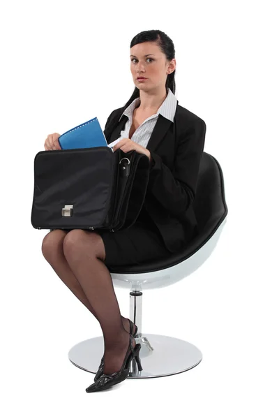 Businesswoman pulling out a document from her briefcase — Stock Photo, Image