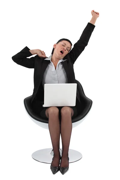 Woman sitting on a chair stretching — Stock Photo, Image