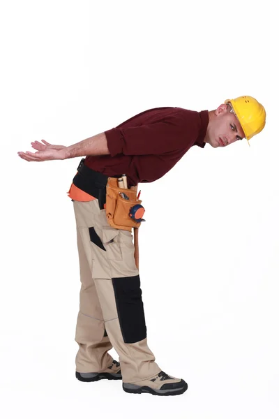 Trabalhador da construção com uma carga pesada imaginada — Fotografia de Stock
