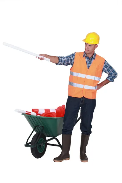 Foreman with plans and a barrow of traffic cones — Stock Photo, Image