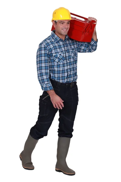 Tradesman carregando sua caixa de ferramentas em seu ombro — Fotografia de Stock