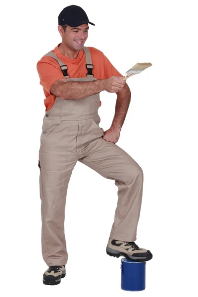 Man holding a paintbrush — Stock Photo, Image