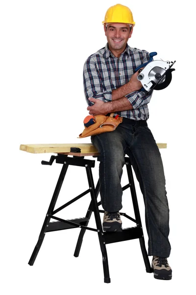 Man perched on work bench — Stock Photo, Image