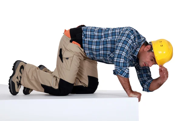 stock image Builder climbing on wall being curious