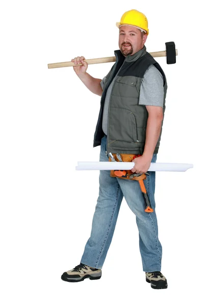 Laborer holding plans and sledge-hammer — Stock Photo, Image