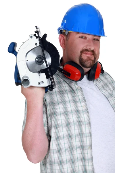 A plumb handyman with a circular saw. — Stock Photo, Image