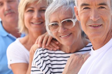 Closeup of two older couples out in the sunshine clipart