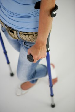 Close-up on a women on crutches clipart