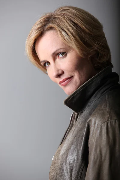 Profile picture of blond woman wearing leather jacket