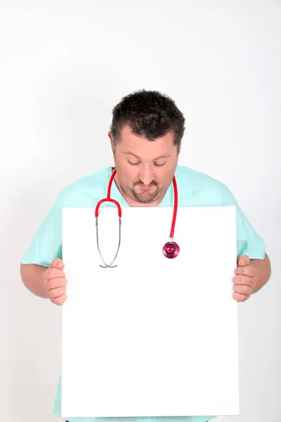 Doctor looking at a blank sign — Stock Photo, Image