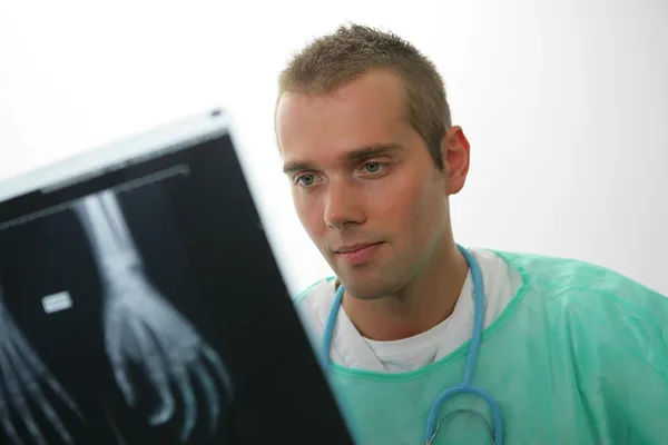 Man holding an x-ray of a hand — Stock Photo, Image