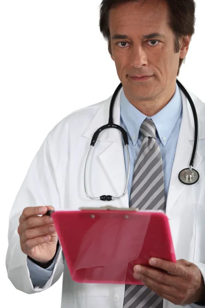 Doctor smiling with clipboard — Stock Photo, Image