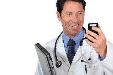 Doctor with a cellphone and laptop computer clipart