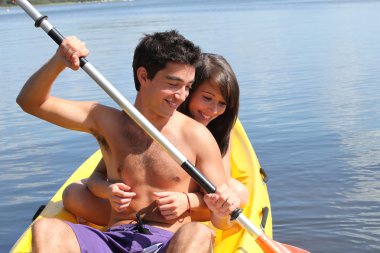 Young couple kayaking clipart