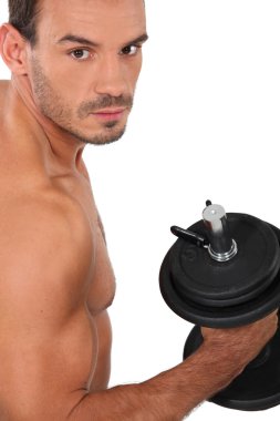 Bare-chested man 30 years old muscular man doing fitness with dumbbell clipart