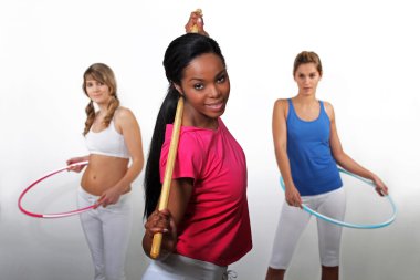 Women working out with hula-hoops clipart