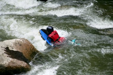 Canoing down rapids clipart