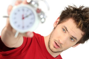 A frazzled man holding an alarm clock clipart
