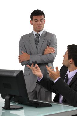 Boss having a discussion with his defensive employee clipart