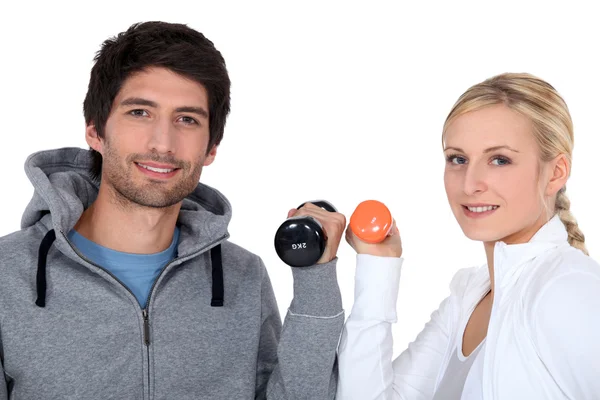 Young couple with dumbbells — Stock Photo, Image