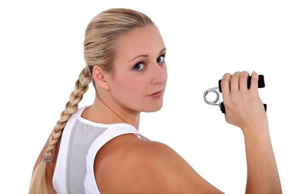 Fit woman holding a gripper — Stock Photo, Image