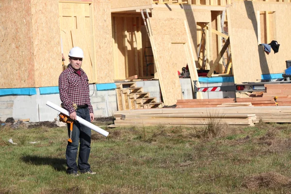 Foreman ficou perto da casa de madeira inacabada — Fotografia de Stock