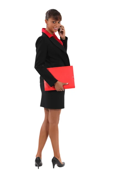 Businesswoman holding document folder and mobile — Stock Photo, Image