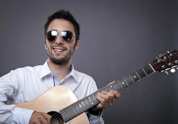 stock image Handsome young man playing guitar