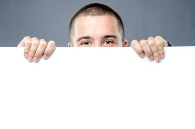 Joyful man protrudes behind white board clipart