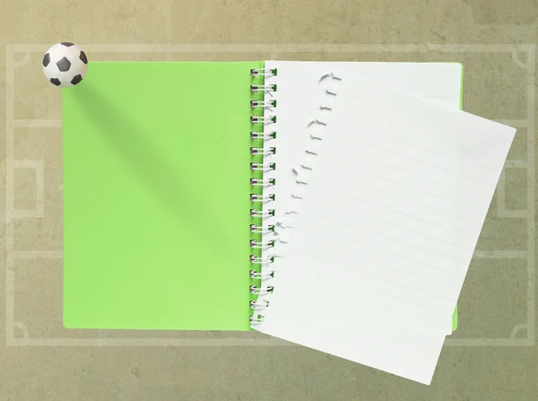 Livro em branco com futebol de plasticina sobre fundo de papel (verde ) — Fotografia de Stock