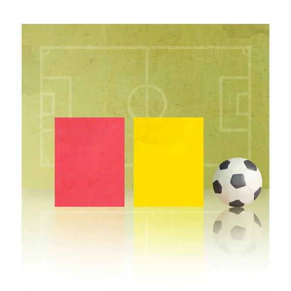 Plasticine football with referee cards on soccer field background — Stock Photo, Image