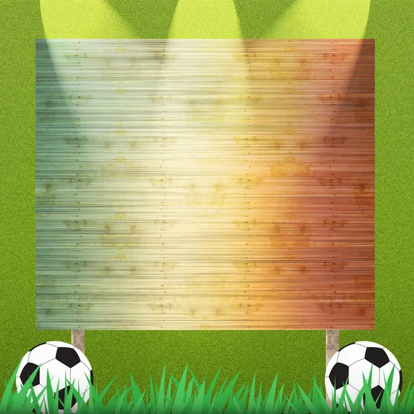 Voetbal en billboard op gras achtergrond en textuur — Stockfoto