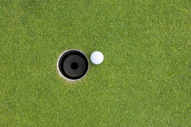 Golf Ball on Edge of Hole clipart