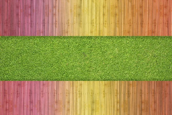 Kleur hout op gras achtergrond en textuur — Stockfoto