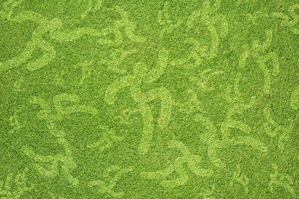 Yeşil çim dokusu ve arka planda çalışan spor — Stok fotoğraf