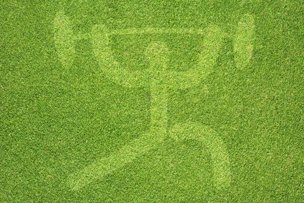 Sport gewicht op groen gras textuur en achtergrond — Stockfoto