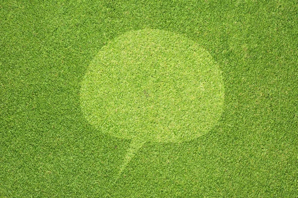 Ícone de comentário na textura de grama verde e fundo — Fotografia de Stock