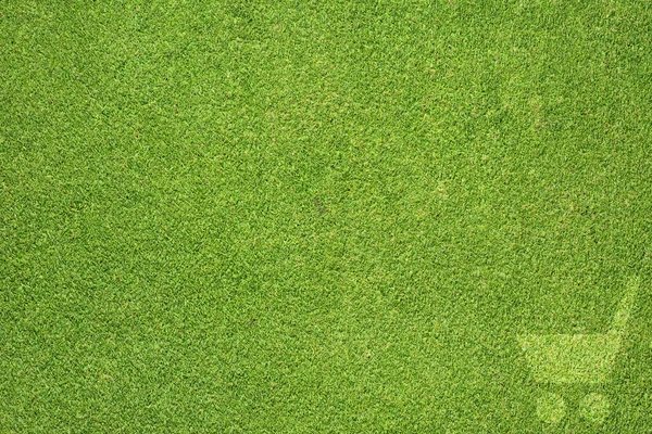 Ícone de carrinho de compras na textura de grama verde e fundo — Fotografia de Stock