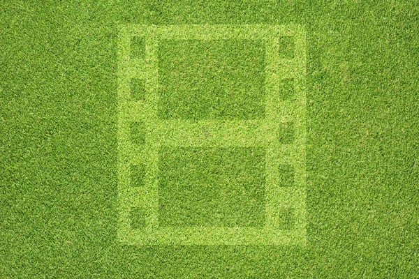 Пленка на зеленой текстуре травы и фоне — стоковое фото