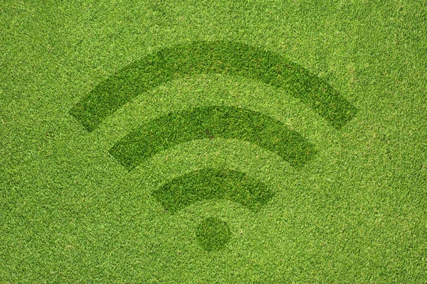 Wireless-Symbol auf grünem Gras Textur und Hintergrund — Stockfoto