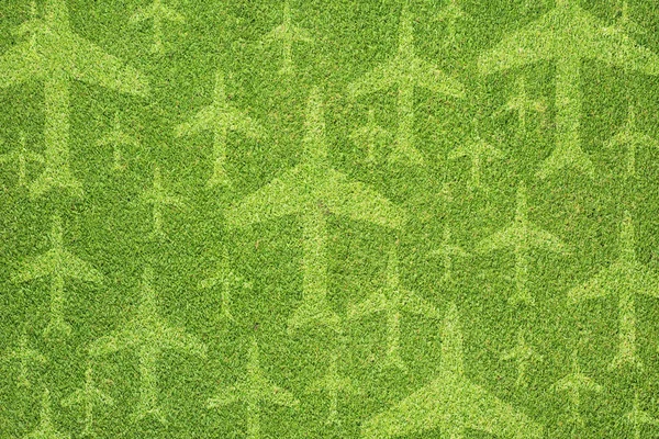 Ícone de avião na textura de grama verde e fundo — Fotografia de Stock