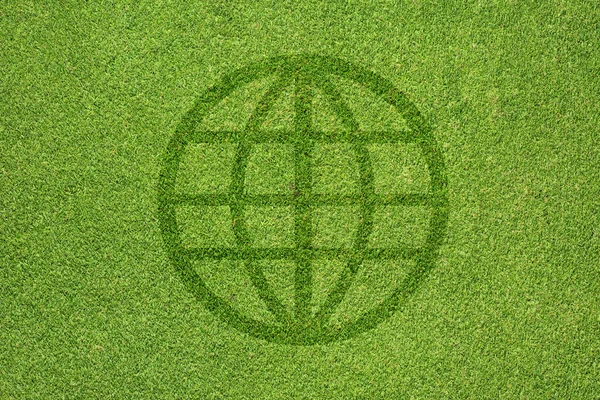 Global icon on green grass texture and background — Stock Photo, Image